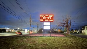 A Beauty Rest Hotel sign with a contact number. - Beauty Rest Hotel (Edison)