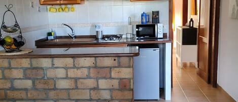 Fridge, microwave, stovetop, coffee/tea maker