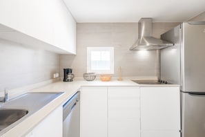 A modern kitchen with stainless steel appliances, a window, and a built-in dishwasher. - Holiday Home 'Sam 3' with Private Pool, Wi-Fi and Air Conditioning (Can Picafort)