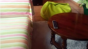 A room with a bed, a desk, a chair, a radiator, a door, and a potted plant. - Holiday Home 'Villa Lukita' with Sea Views, Wi-Fi and Air Conditioning (Cangas)
