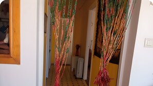 A hallway with a tiled floor, a radiator, and a door at the end. - Holiday Home 'Villa Lukita' with Sea Views, Wi-Fi and Air Conditioning (Cangas)