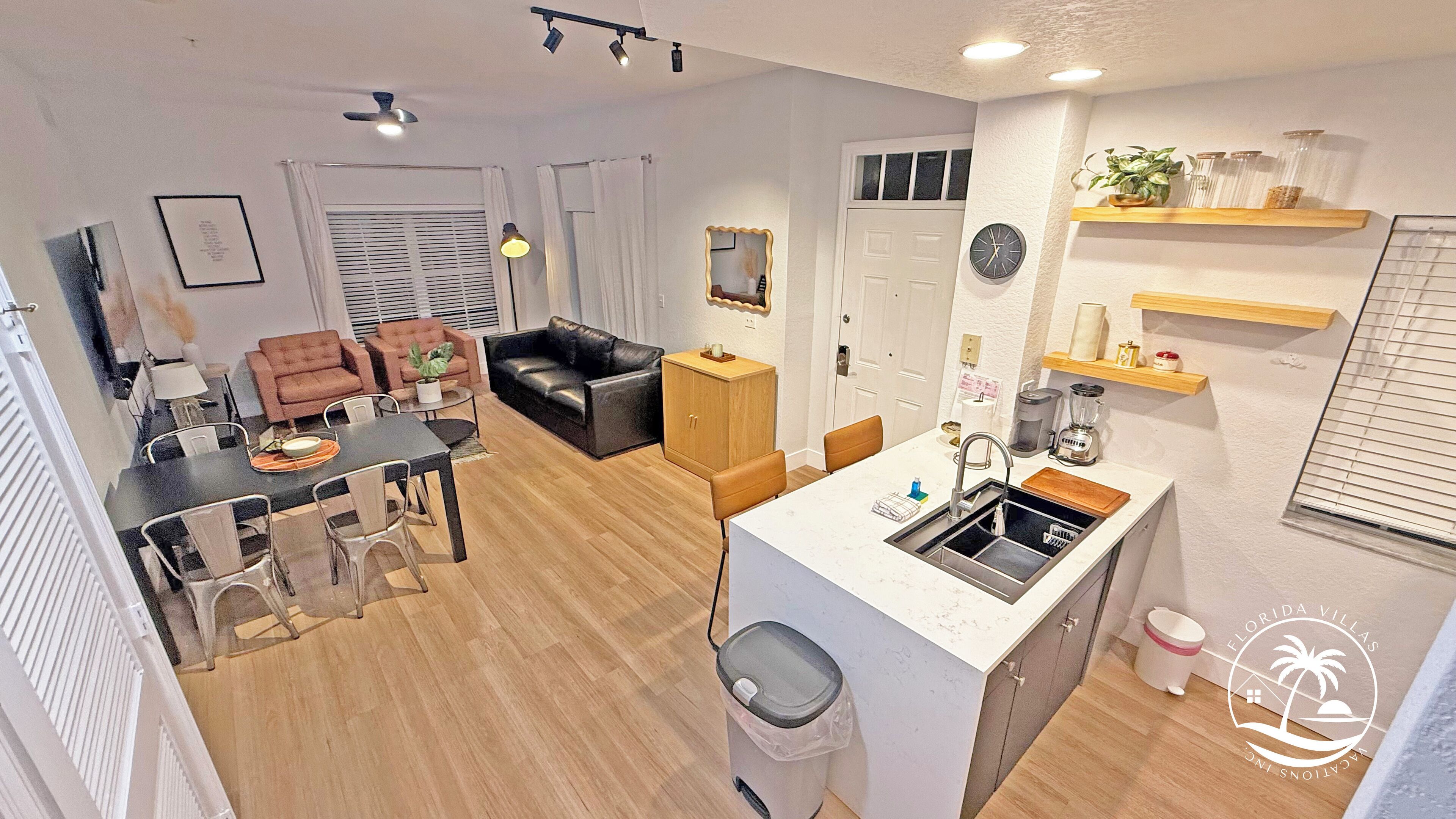 Un apartamento moderno con comedor, sala de estar y cocina.