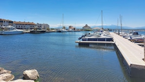 A marina with boats docked, a pier, and buildings in the background. - Les Marquises by Interhome (Le Barcarès)