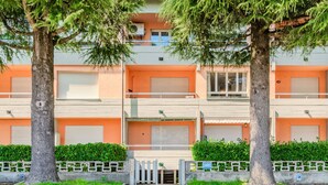 A multi-story residential building with a flat facade, large windows, and a gated entrance. - Al Molo by Interhome (Domaso)