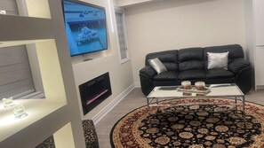 TV, fireplace - The Luxe Haven (East Gwillimbury)