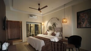Une chambre moderne comprenant un lit, un bureau, une chaise, un ventilateur de plafond et un tableau représentant un tigre accroché au mur.
