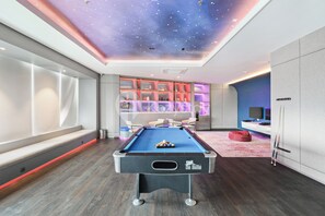 Enjoy a game of pool or relax in a seating area with a TV nearby.