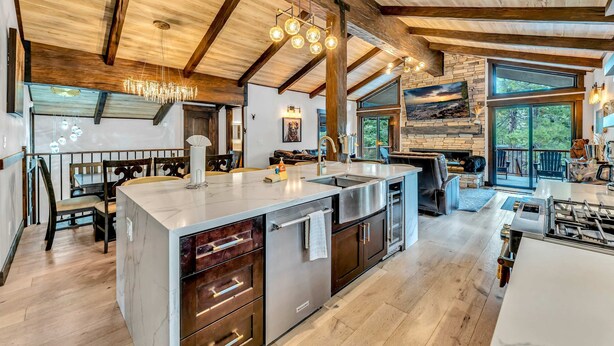A spacious kitchen with a large island, wooden beams, and a view of the outdoors. - Fire and Ice/Northstar Resort Truckee, CA (Truckee)