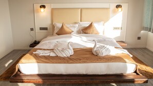 A neatly made bed with a wooden frame, two wall-mounted reading lights, and a brown headboard. - Spellmount - Himalayan View Infinity Pool Resort In Kausani (Kausani)