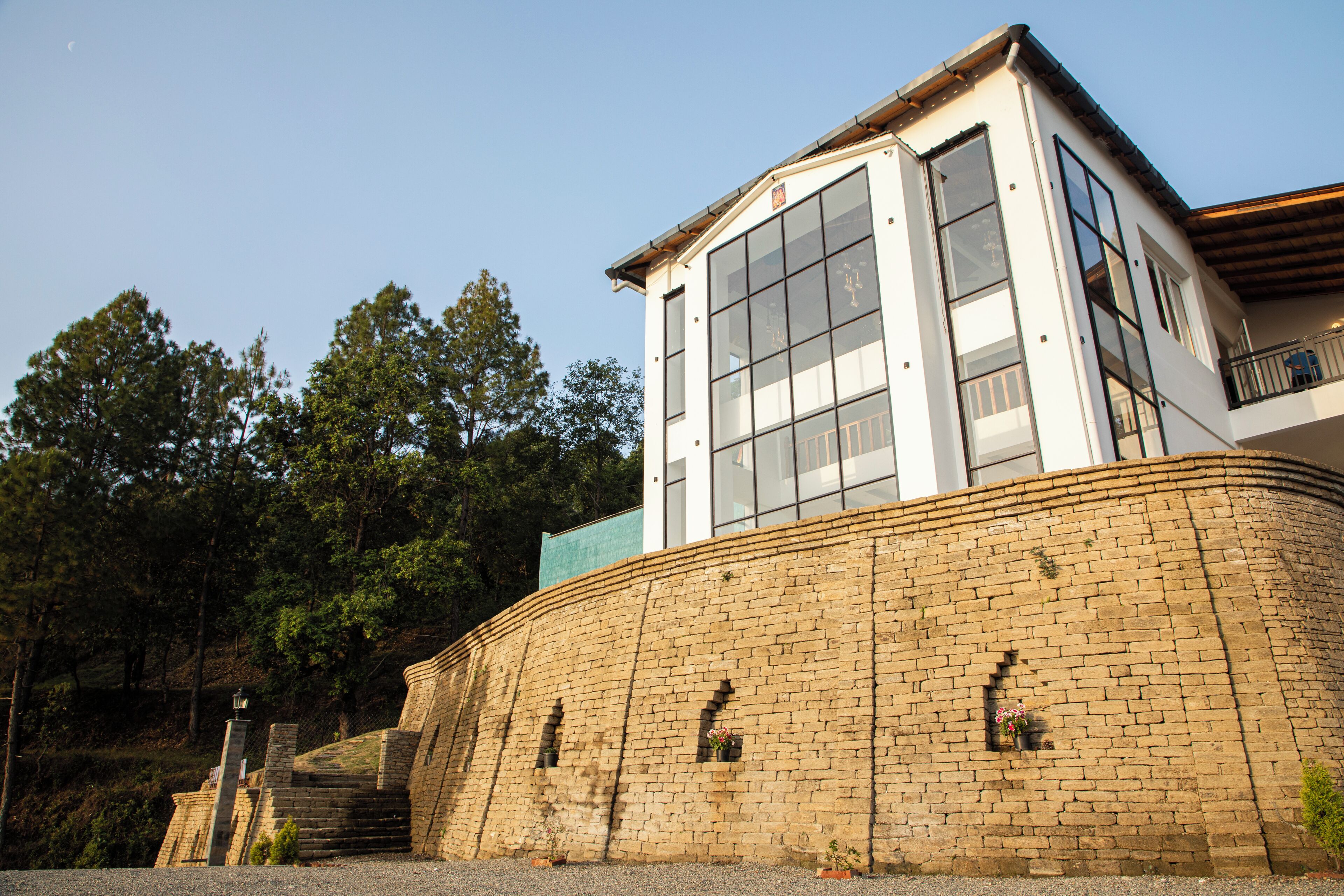 A building with a brick facade, large windows, and a balcony.