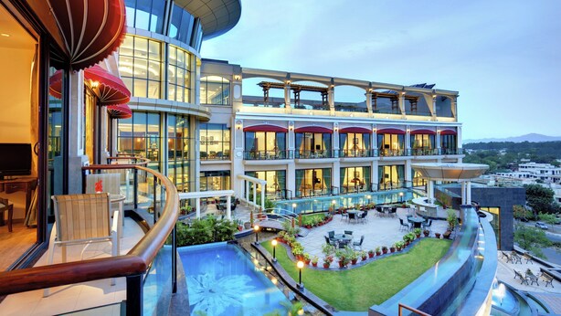 A modern hotel with a pool, outdoor seating, and a view of the city. - The BellaVista Hotel Chandigarh Panchkula (Panchkula)