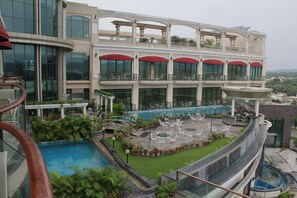 A hotel with a rooftop pool, outdoor seating, and a view of the surrounding landscape. - The BellaVista Hotel Chandigarh Panchkula (Panchkula)