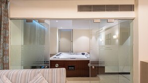 A modern bathroom with a glass-enclosed shower, a wooden vanity, and a large bathtub. - The BellaVista Hotel Chandigarh Panchkula (Panchkula)