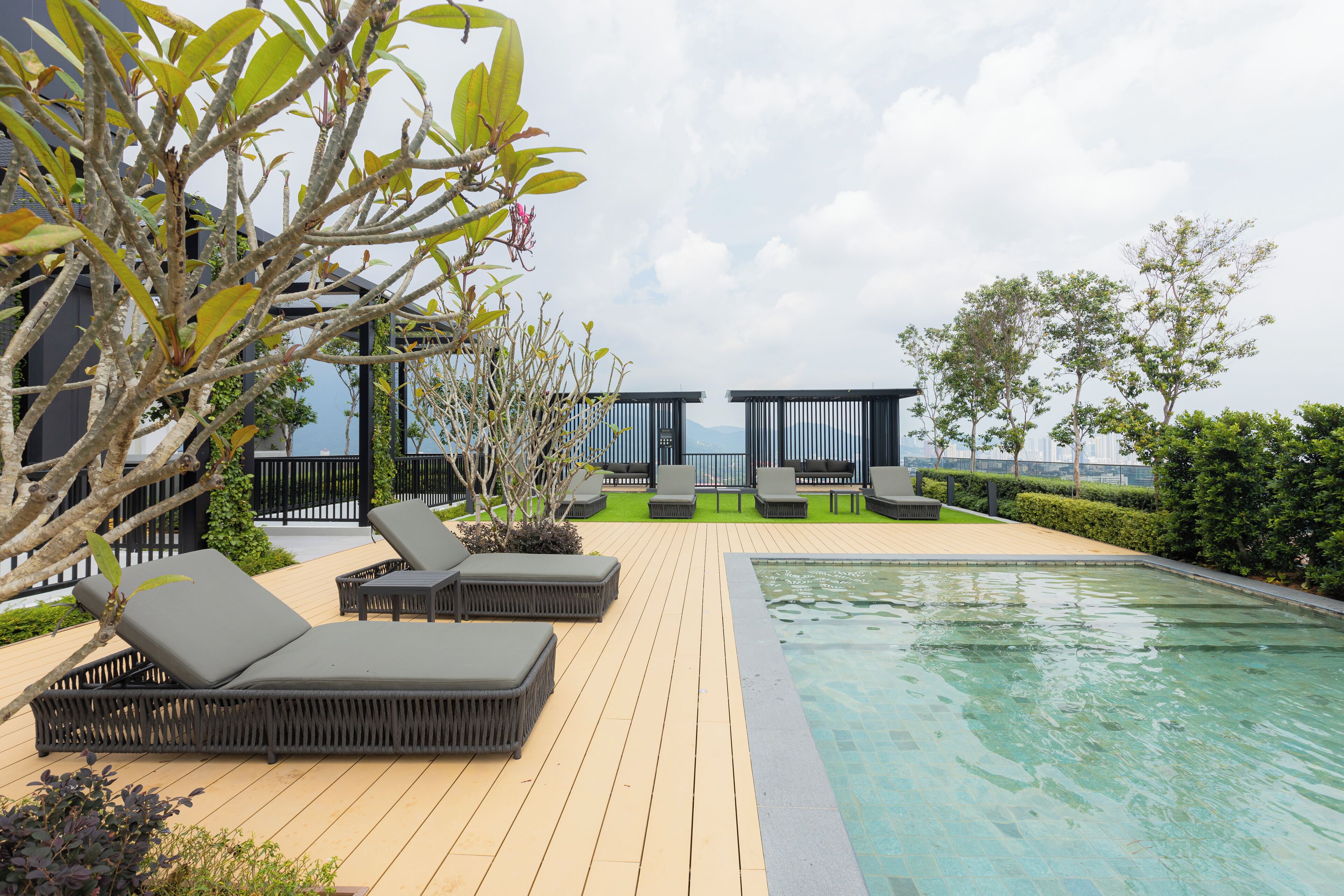 A poolside area with lounge chairs and a pool.