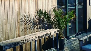 A wooden exterior with a sign reading "Drifters Kitchen Bar." - Stylish Ground Floor Apartment with Sea Views (East Wittering)