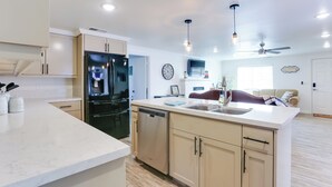 A modern kitchen with a large island, built-in appliances, and pendant lighting. - Mtn-View Home w/ Patio & Grill in Woodlake (Woodlake)