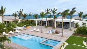 A resort with a pool, lounge areas, and a view of the ocean. - 4 BR All-Inclusive Villa @ Ambergris Cay: Dream Away (Big Ambergris Cay)