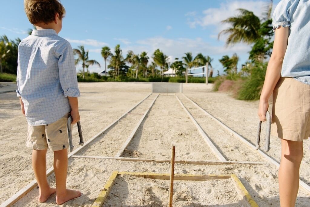 A beach volleyball court with a net and sand.