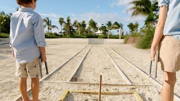 A beach volleyball court with a net and sand.
