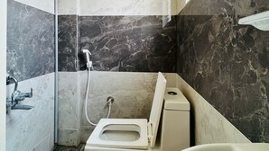 Une salle de bain comprenant des toilettes, une douche et une baignoire.