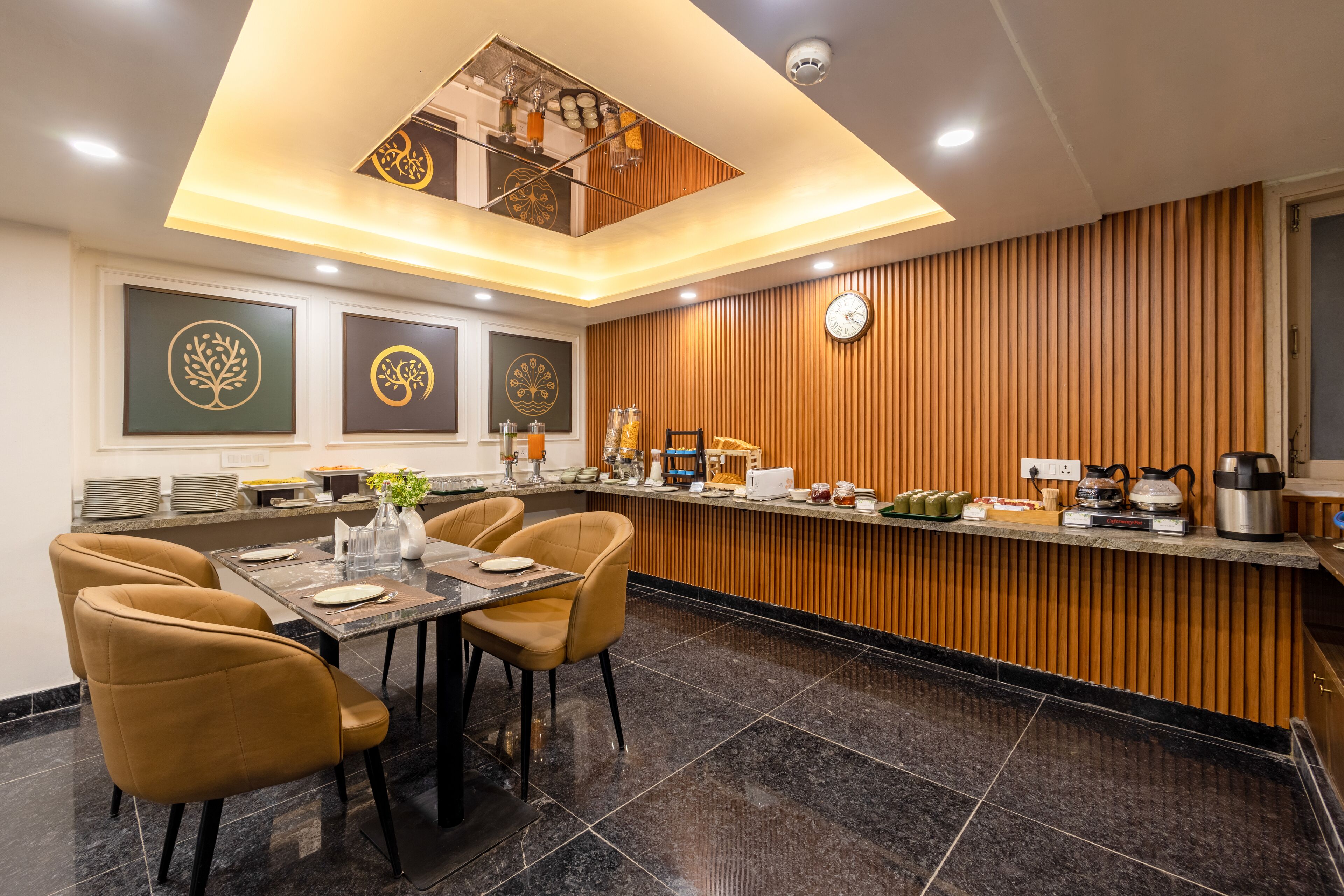 A modern kitchen with a central island, wooden paneling, and a clock on the wall.