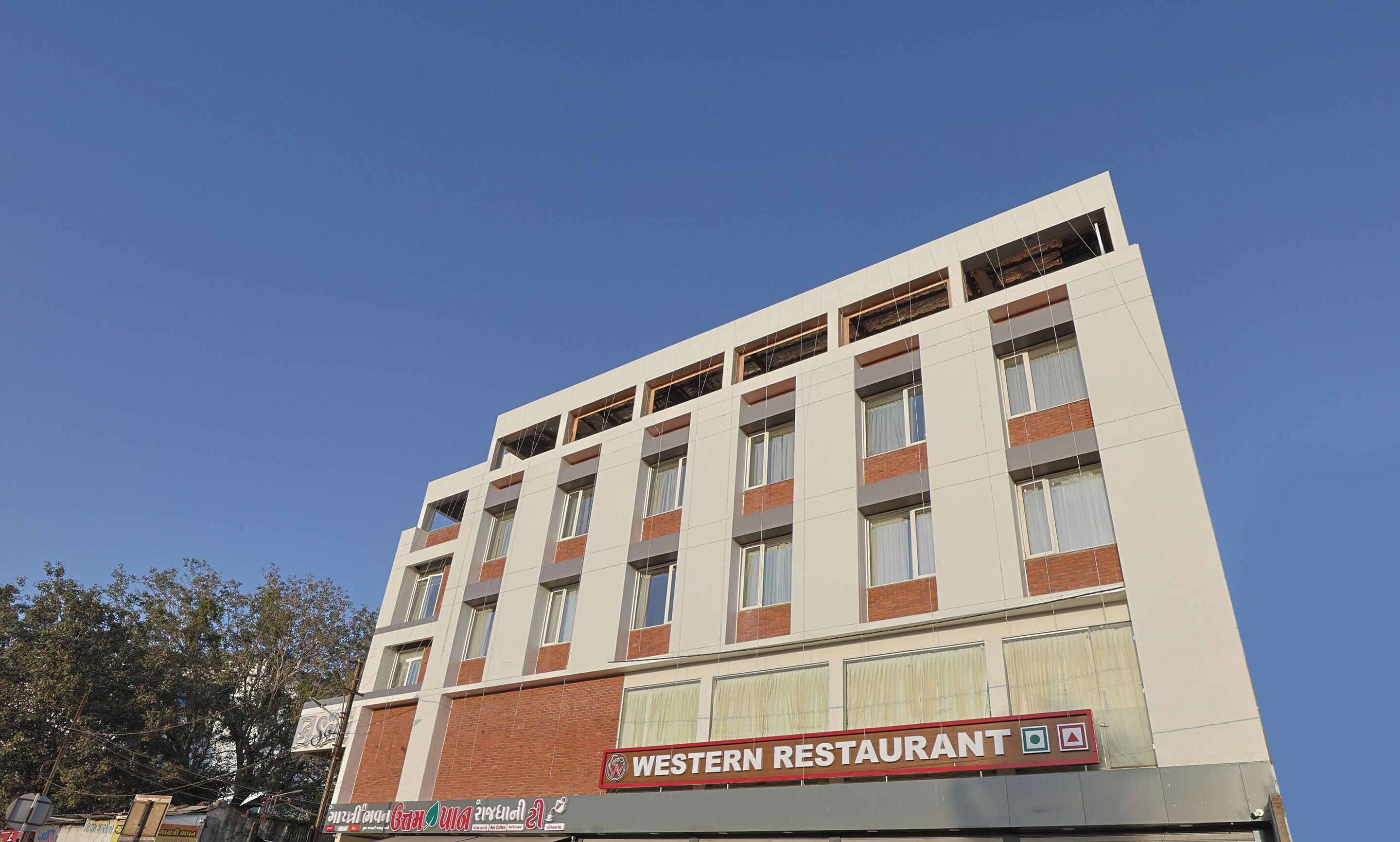 A multi-story building with a sign for 'Western Restaurant' on the ground floor.