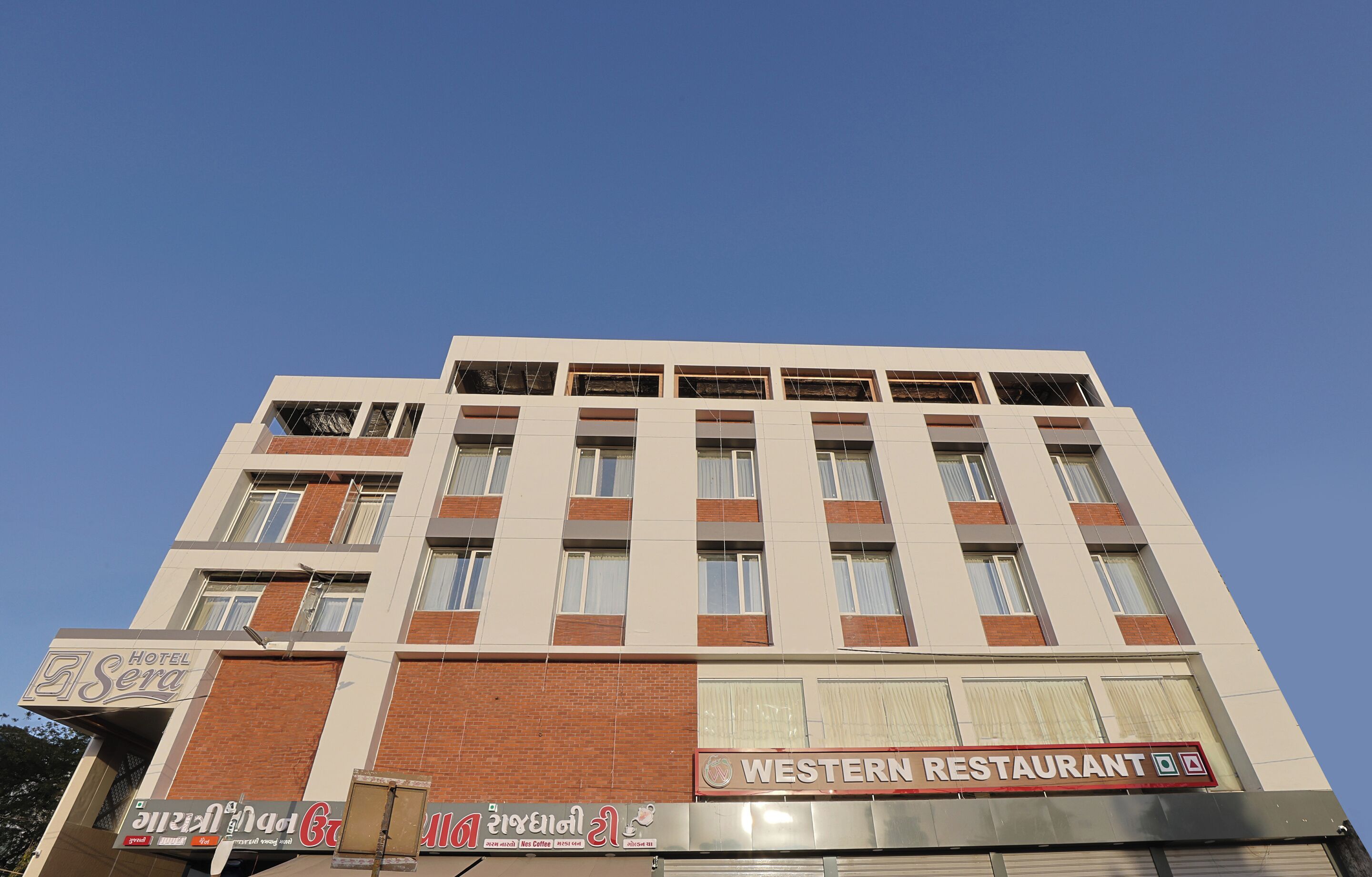 A multi-story building with a sign for 'Hotel Sera' and a 'Western Restaurant' on the ground floor.