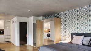 Ein modernes Schlafzimmer mit einem Bett, einem Nachttisch und einer Wand mit Muster.