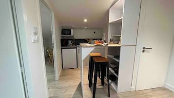 Fridge, microwave, coffee/tea maker, cookware/dishes/utensils