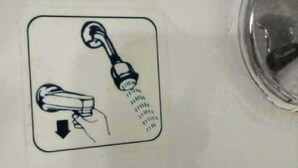 A bathroom sink with a hand-dryer and a faucet.