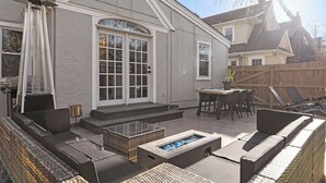 A backyard patio with a built-in fire pit, outdoor seating, and a pergola. - Casa Brookside - Brookside + Walkable + Firepit (Kansas City)