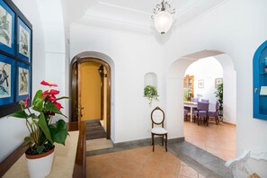 Enter a clean and inviting space with a clear pathway to the dining area, featuring a table, chairs, and a cabinet.