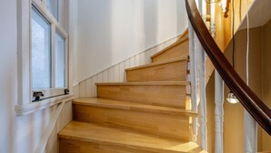 A wooden staircase with white trim and a dark wooden handrail. - Balat 5 (Fatih)