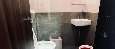 Ein kleines Badezimmer mit Toilette, Bidet und Waschbecken.
