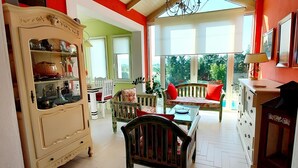 A room with a dining area, a large cabinet, and a view of the outdoors. - Villa Avra - Private Garden Pool Oasis in Drama (Drama)