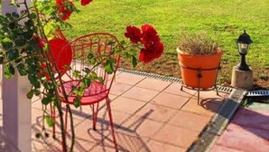 A patio with a pool, red chairs, and potted plants. - Villa Avra - Private Garden Pool Oasis in Drama (Drama)