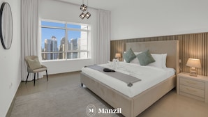 A modern hotel room with a large bed, a chair, a nightstand, and a view of the city skyline. - Manzil-1BR near JBR Beach & Blue Waters  (Dubai)