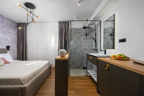 A modern bedroom with a bed, bedside table, and a nightstand with a vase. - Room in Porec by Old Town & Waterfront (Porec)