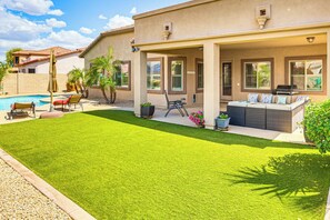 A house with a covered patio, a swimming pool, and a well-maintained lawn. - Backyard Oasis w/ Fire Pit: Laveen Village Retreat (Laveen)