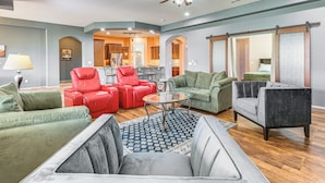 A spacious living room with a ceiling fan, a dining area, and a kitchen in the background. - Backyard Oasis w/ Fire Pit: Laveen Village Retreat (Laveen)