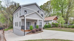 A two-story house with a front porch, a covered entryway, and a small front yard with landscaping. - 3 Mi to Mercedes-benz: Home w/ Office & Backyard! (Atlanta)