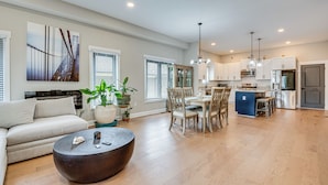 A spacious living room with a sofa, a coffee table, and a dining area with chairs and a table. - 3 Mi to Mercedes-benz: Home w/ Office & Backyard! (Atlanta)