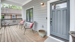A wooden deck with outdoor furniture and a grey door. - 3 Mi to Mercedes-benz: Home w/ Office & Backyard! (Atlanta)