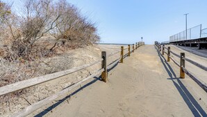 A sandy pathway with wooden railings leading to a beach. - Walk to Beach: North Wildwood Condo w/ Pool Access (North Wildwood)