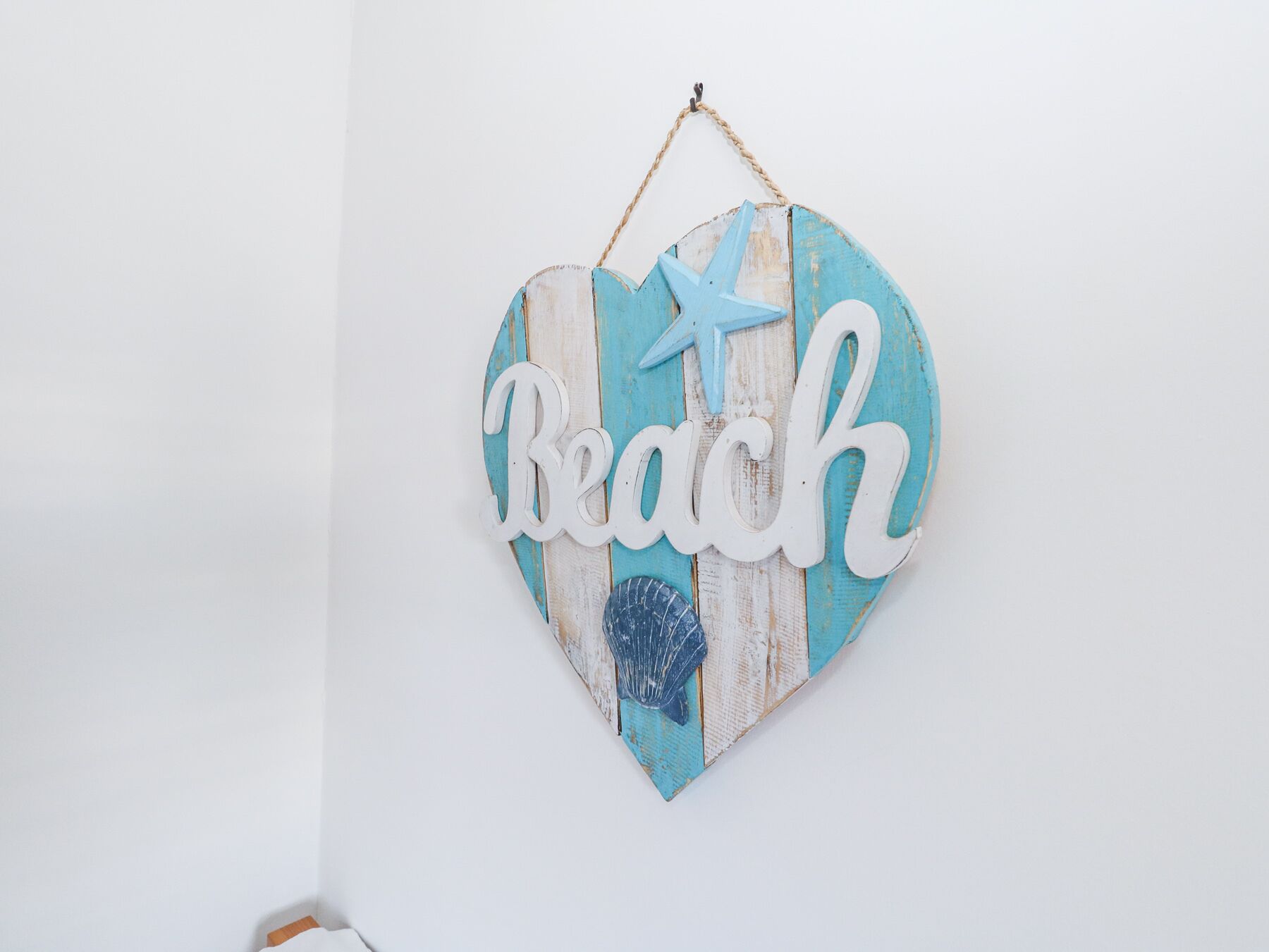 A heart-shaped sign with the word "Beach" and a star decoration.