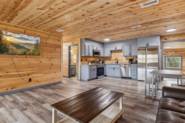 Enjoy a warm and inviting space with a large flat-screen TV, comfortable seating, and a fully equipped kitchen.