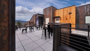 Terraço no telhado com área de estar externa e vista para as montanhas.