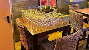 A dining area with a long table set for a meal, wicker chairs, and a decorative bowl on the table. - Parkhotel & Kurcafe Bad Sassendorf (Bad Sassendorf)