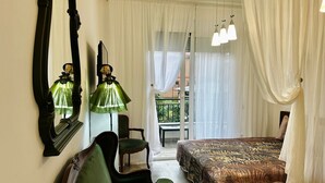 A bedroom with a bed, a chair, a mirror, and a window with curtains. - Charming apartment with WiFi, AC in fabulous Bar (Bar)