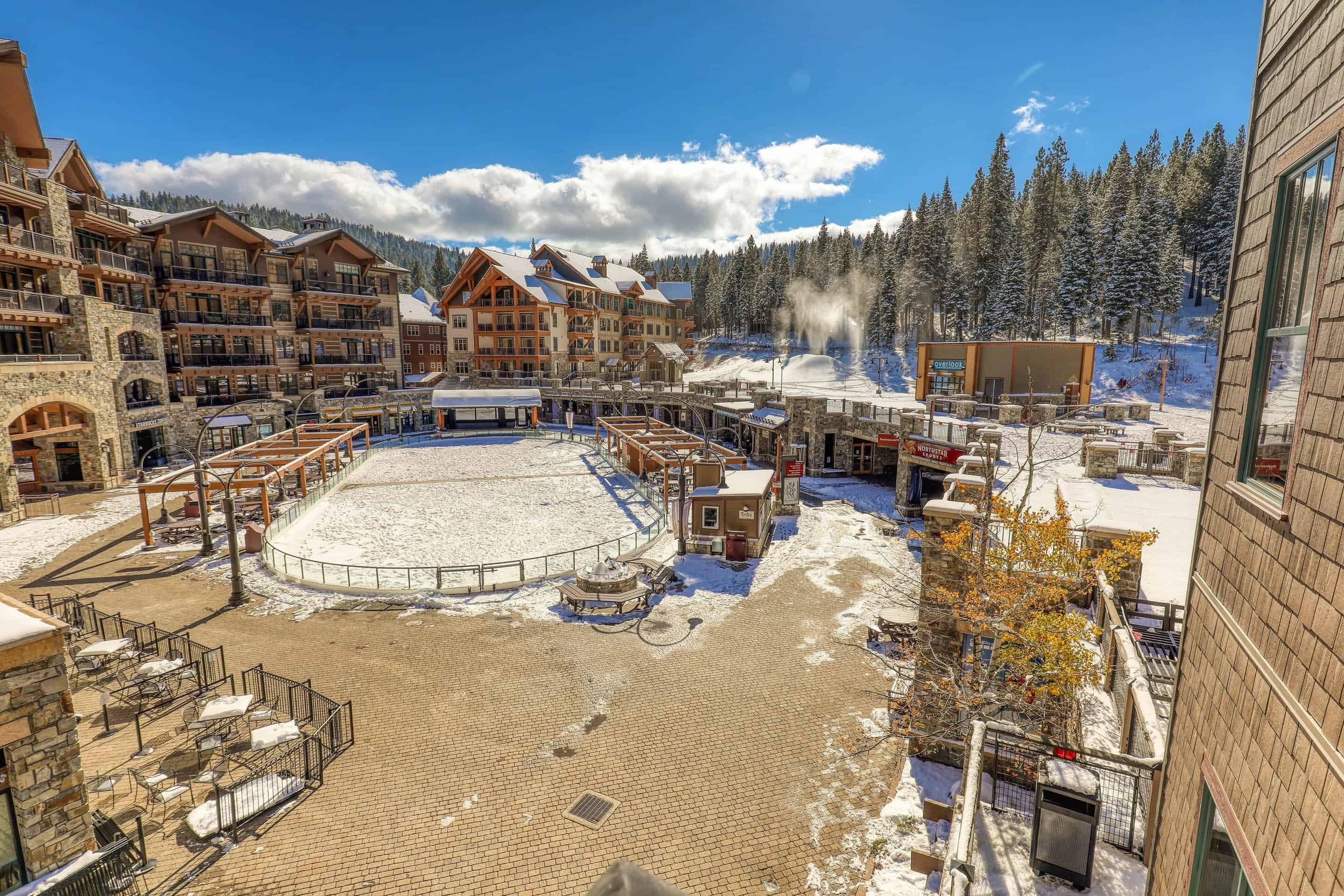 A ski resort with a central plaza, multiple lodges, and a snow-covered landscape.